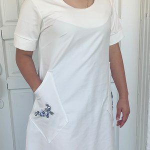 Women white dress with flowered pockets